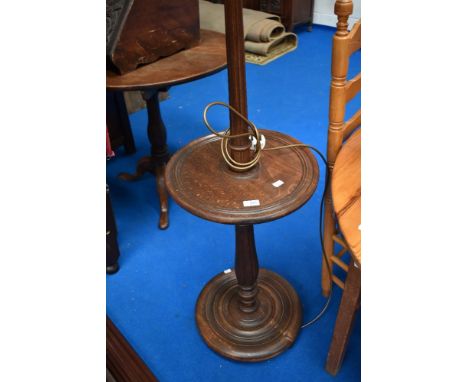 An early 20th Century mahogany standard lamp with integral table and handkerchief style fabric shade