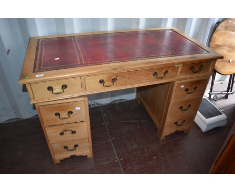 A reproduction Regency pedestal desk, light colour