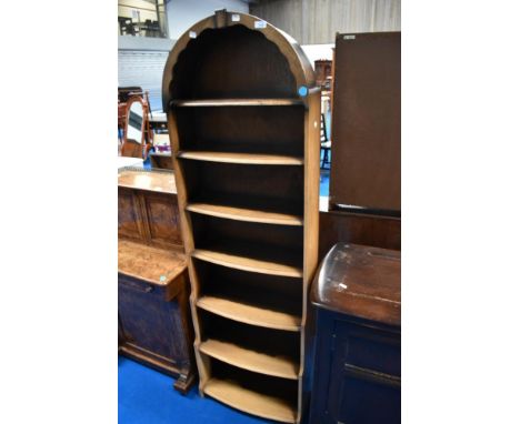 A vintage narrow bookshelf having waterfall style base