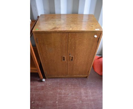 A vintage golden oak record cabinet