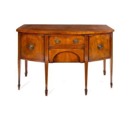 George III-style inlaid mahogany bow front sideboard with central drawer and frieze drawer below flanked by two cupboards, on