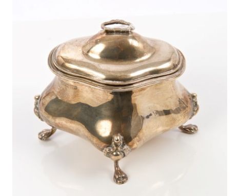 Edwardian silver tea caddy of bombe form, with domed hinged cover and swing handle, on four decorative paw feet (Chester 1904