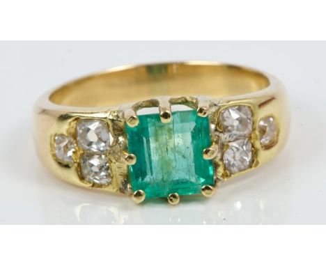 Victorian emerald and diamond ring with a rectangular step cut emerald flanked by old cut diamonds to the shoulders.  Ring si