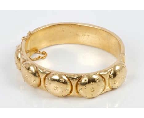 19th century yellow metal hinged bangle with five domed panels with polka-dot decoration