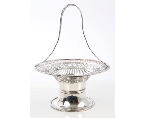 George V silver basket of circular form, with pierced decoration and reed and ribbon border, tall fixed pierced handle and pe