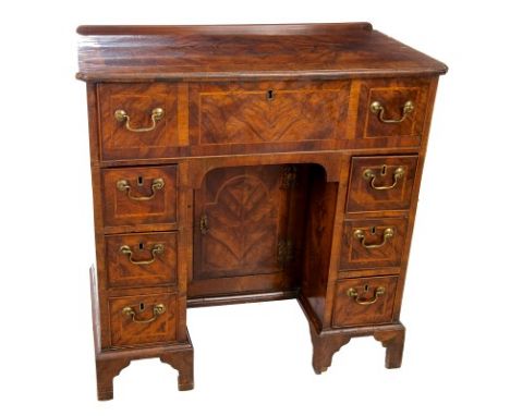 Georgian and later walnut knee-hole writing desk with crossbanded decoration, quarter-veneered top with inlaid central star, 