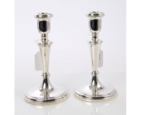 Pair contemporary silver candlesticks of tapering form, with inverted bell candle holders, on circular pedestal bases (Sheffi