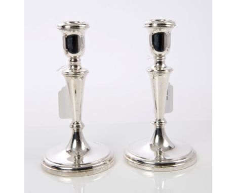 Pair contemporary silver candlesticks of tapering form, with inverted bell candle holders, on circular pedestal bases (Sheffi