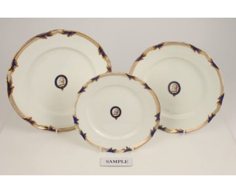Eleven mid-19th century English armorial plates with central painted unicorn crest within garter motto 'So Fork Forward' and 
