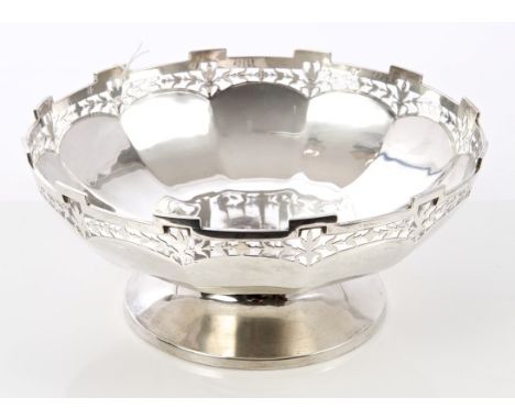 1920s silver bowl of faceted circular form, with pierced castellated border and central presentation engraving, on a circular
