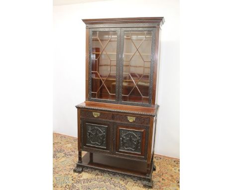 Good quality Edwardian carved mahogany two height bookcase with shelves above enclosed by two astragal glazed doors with blin