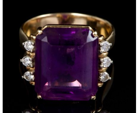 Amethyst and diamond cocktail ring with a large rectangular step cut amethyst measuring 15.82mm x 13.30mm, flanked by three b