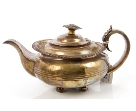 William IV silver teapot of compressed circular form, with belt of reeded decoration, gadrooned border and silver scroll hand