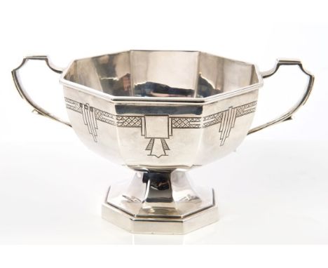 1930s silver two-handled dish of octagonal faceted form, with engraved Art Deco-style decoration, on an octagonal faceted ped