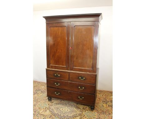 19th century mahogany linen press on chest with slides, enclosed by two panelled doors and two short and two long drawers bel