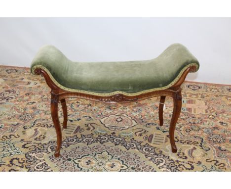 Early 20th century French dressing stool with green upholstery, scroll ends on carved cabriole legs, 80cm wide