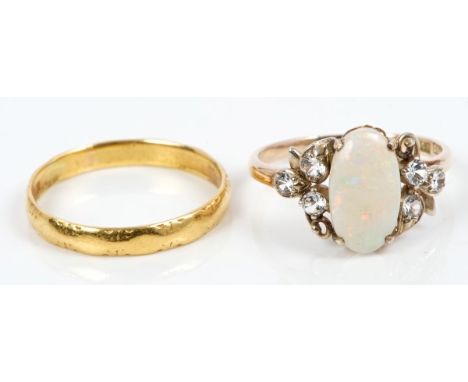 Opal and white stone dress ring in yellow metal setting.  Ring size O and a gold (22ct) wedding ring.  Size Q (2)