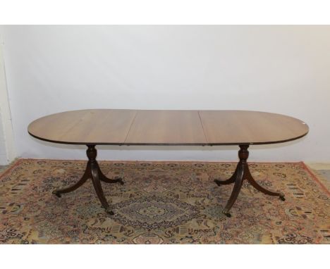 Georgian-style mahogany twin pedestal D-end dining table with extra leaf, bearing label - Redman & Hales, opening to 245cm x 