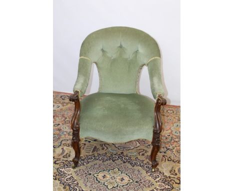 Victorian mahogany framed button back tub-shape open armchair with green upholstery, scroll arms, on carved cabriole front le