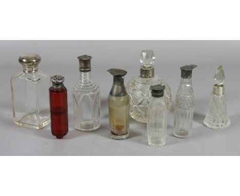 A collection of eight silver collared perfume and cruet bottles to include a ruby hexagonal double ended perfume bottle.