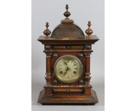 A mahogany cased bracket clock chiming on a coiled gong.