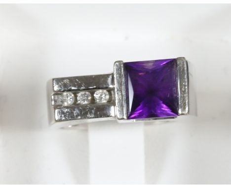 A 14 carat white gold modernist ring set with amethyst and diamonds, size M.