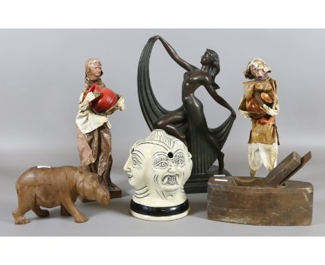 An Art Deco style figure and a four face ceramic ornament along with a pair of papier mache figures, a carved hippo and a blo