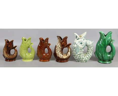 Six ceramic water jugs in the form of fish to include Dartmouth and Fosters studio etc.