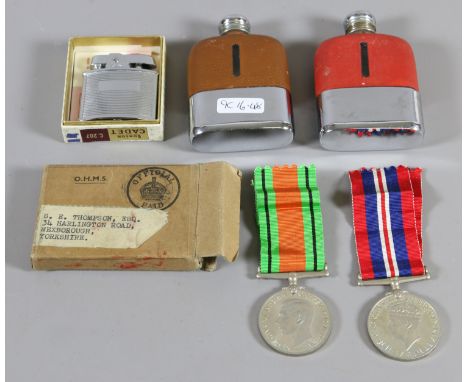 Two chrome and leather covered hip flasks, a Ronson Cadet cigarette lighter and two second World War medals.