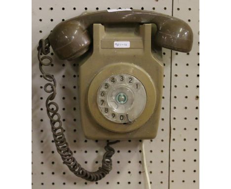 A 1970s retro British Telecom wall mounted telephone and bracket.