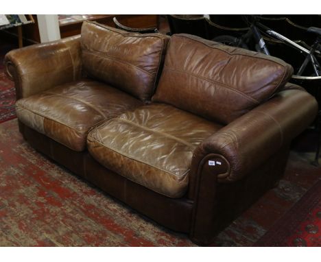 A large brown leather sofa retailed by The House of Fraser.