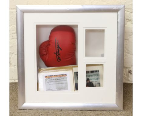 A Joe Frazier signed Everlast boxing glove with certificate of authenticity and photograph of provenance.