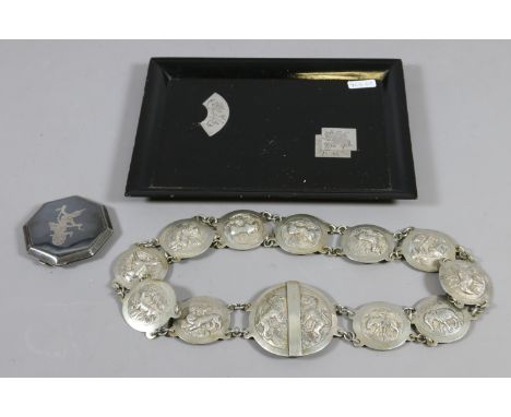 A Sterling Siam silver compact and a Japanese lacquered tray along with a white metal belt decorated with animals.
