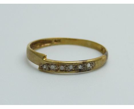 A 9ct gold ring set with six diamonds, 0.6g, O 