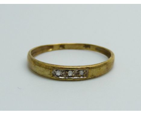 A 9ct gold three stone diamond ring, 0.7g, O 