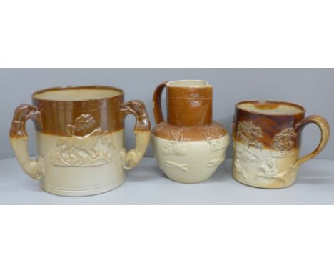 A Victorian saltglaze tyg with three greyhound handles, a hunting jug and mug (3) 