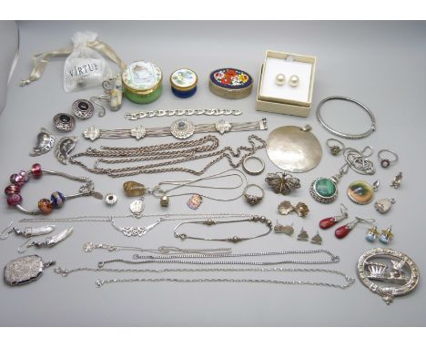 A collection of silver and white metal jewellery including a silver charm bracelet, chains, pendants, earrings, rings, a ston
