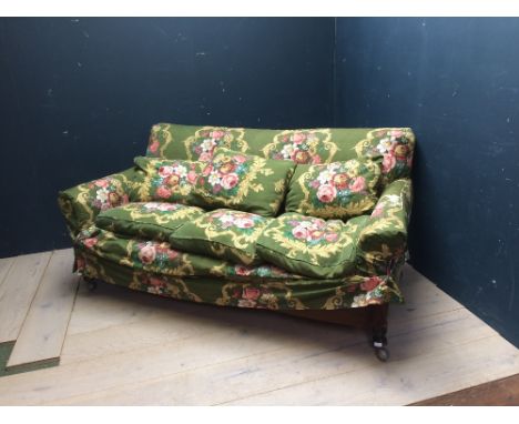 3 seater sofa in removable floral upholstery on mahogany legs & brass castors, 200L x 110W cm