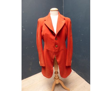 Red hunting coat, with brass buttons, bears label Jones Chalk & Dawson, 6 Sackerville St Piccadilly W, 1975