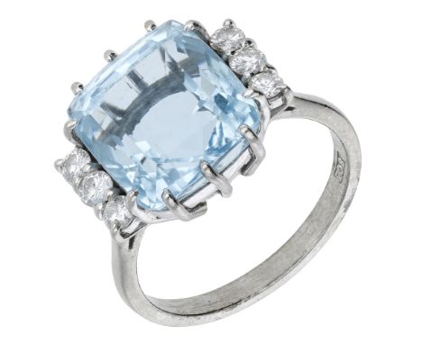 An aquamarine and diamond ring, the cushion-shaped aquamarine claw-set between trios of brilliant-cut diamonds, stamped ‘18ct