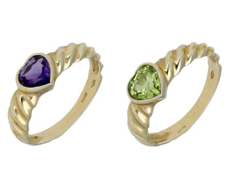 Two 18ct gold and gem-set heart rings, of reeded design, collet set with a heart-shaped amethyst and peridot respectively, st