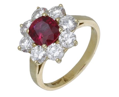 A ruby and diamond cluster ring by Kutchinsky, 1989, the cushion-cut ruby within a flowerhead setting of brilliant-cut diamon