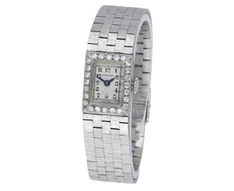 Swiss. Retailed by Benson. A lady’s platinum and diamond-set rectangular wristwatch with later white gold bracelet, circa 193