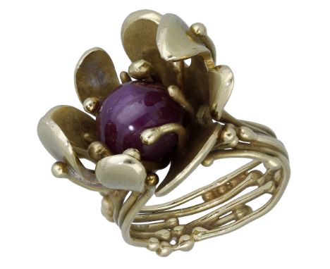 An 18ct gold star ruby ring by Ingeborg Bratman, 1971, the stylised flower head of fluid design, with wavy petals and stamen,