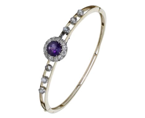 A 19th century amethyst, diamond and seed pearl set bangle, the double hinged bifurcated bangle set to the front with an amet