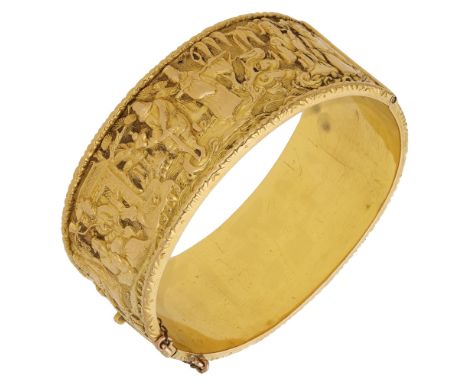 A late 19th century Chinese export gold bangle retailed by Wang Hing, the hinged broad bangle decorated throughout in relief 