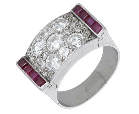 A ruby and diamond dress ring, circa 1940, of odeonesque design, pavé-set with old brilliant and single-cut diamonds between 