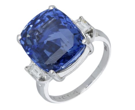 A Sri Lankan sapphire and diamond ring, the cushion-cut sapphire in a four claw setting, between baguette-cut diamond shoulde