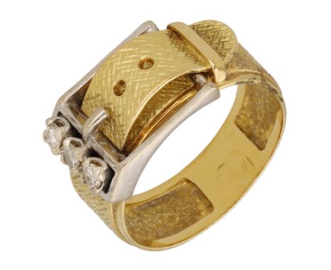 A diamond buckle ring, of two colour gold, set with three brilliant-cut diamond highlights, and crosshatched textured finish,