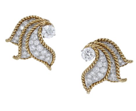 A pair of diamond ear clips, circa 1960, the bicoloured sprays each set with an old brilliant-cut diamond, with scrolled peta